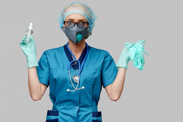 Medical doctor nurse wearing protective mask and holding bottle of sanitizing spray 