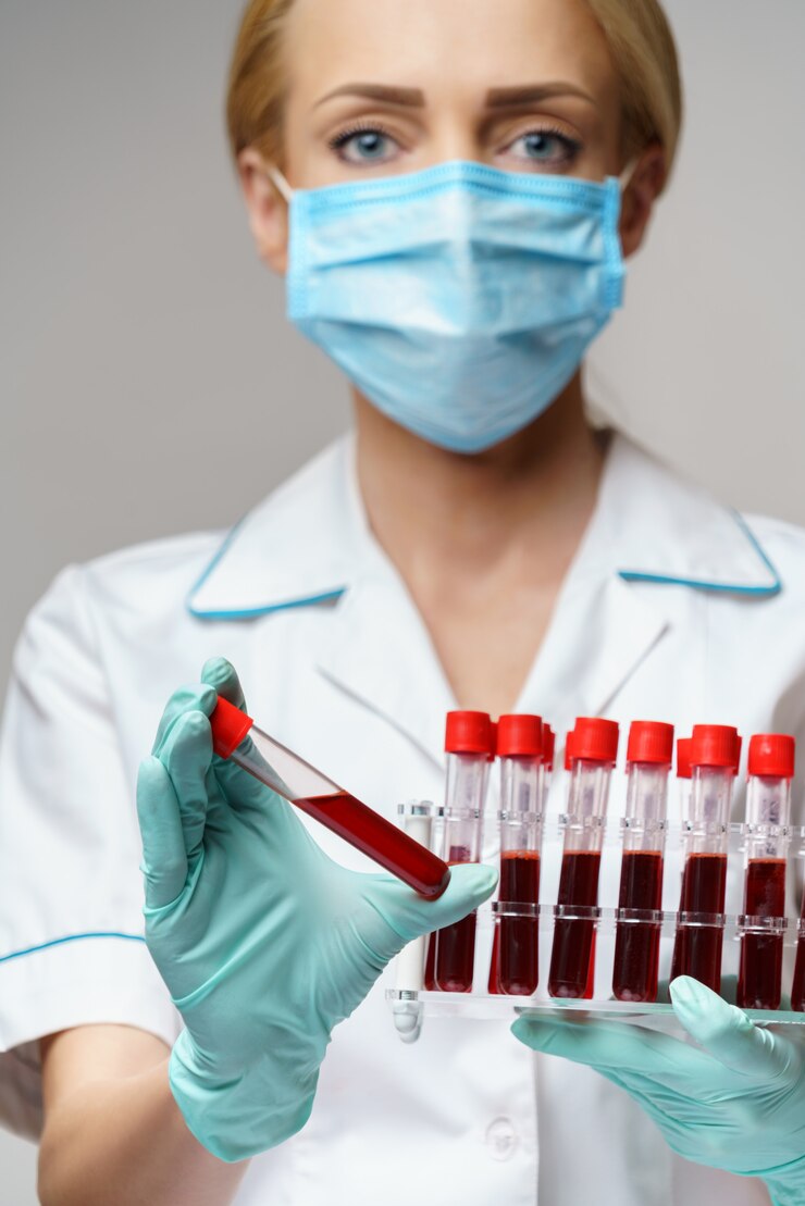 Medical doctor nurse woman wearing protective mask and gloves - holding rack with virus blood tests