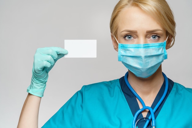 Medical doctor nurse woman wearing protective mask and gloves - showing blank business card