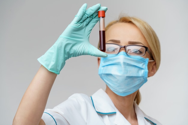 Medical doctor nurse woman wearing protective mask and gloves