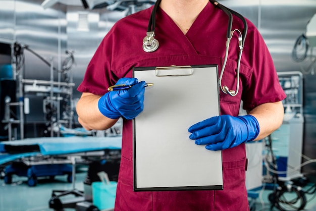 Medical doctor wear uniform and gloves stethoscope stand with medical pad clipboard in hospital room