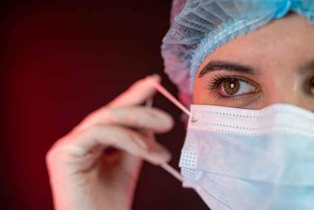 medical doctor woman takes off the mask