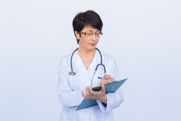 Medical doctor writing prescription over white background.