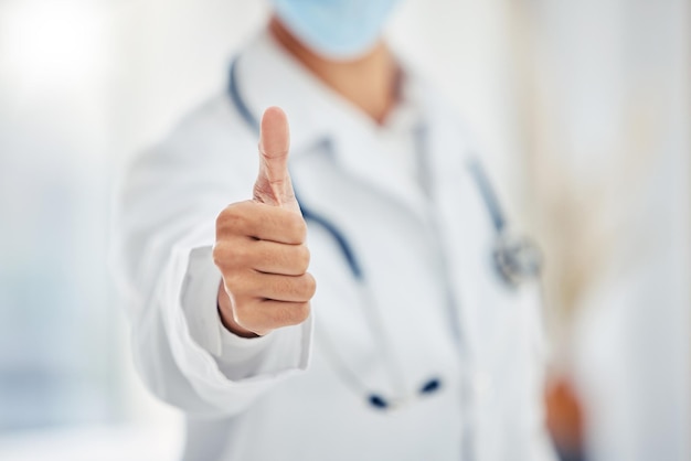 Medical doctors hand show thumbs up for success or goal working at a hospital Giving support motivation and good service in an office at clinic Healthcare worker showing winning sign or emoji