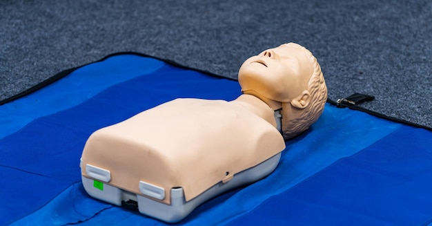 Medical doll on blue blanket for training medic students .\
concept of medical education and practice. first aid help.