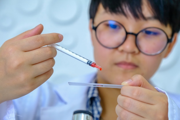 Medical equipment. Blood test.Pipette adding fluid to one of several test tubes