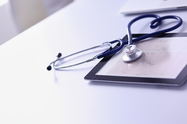 Medical equipment: blue stethoscope and tablet on white background. Medical equipment.