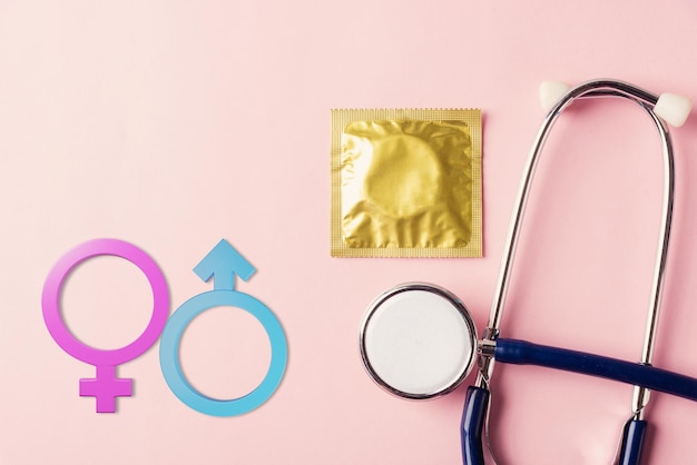 Medical equipment condom in pack doctor stethoscope and Male and female gender signs
