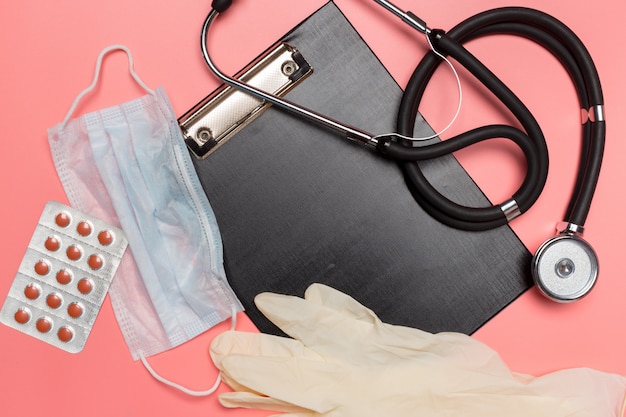 Medical equipment on a pink pastel background.