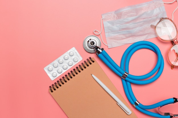 Medical equipment on a pink pastel background.