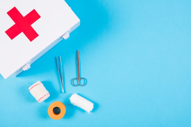 Medical equipments with first aid kit on blue background