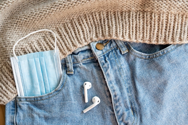 Medical face mask in the jeans pocket