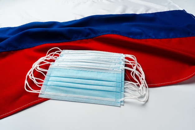 Medical face masks on flag of Russia close up