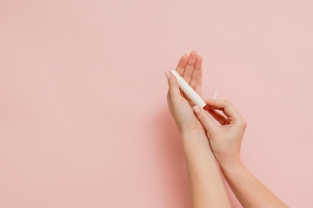 Medical feminine tampon in hand Cotton swab Menstruation