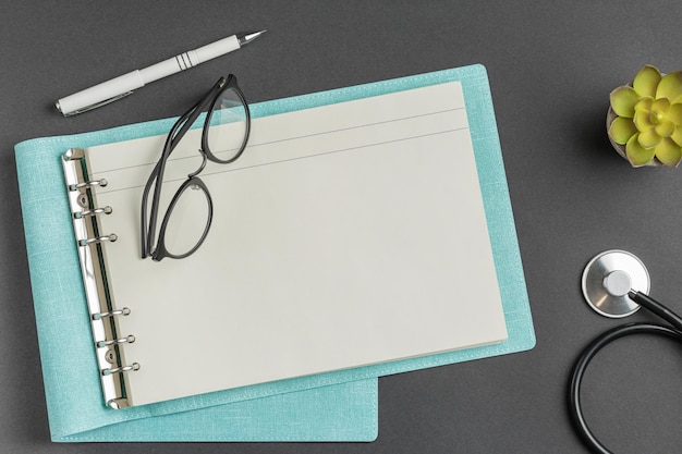 Medical folder with glasses on black background