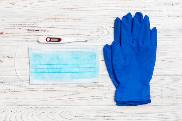 Medical gloves, digital thermometer and surgical mask