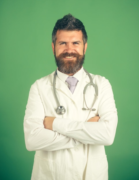 Medical and healthcare concept friendly doctor with stethoscope in hospital physician with beard