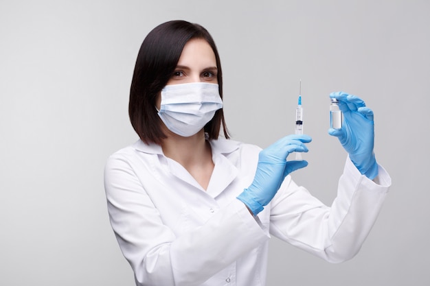 Medical injection,diseases,health care,science,diabetes.Doctor or nurse in hospital holding a syringe with liquid vaccines preparing to do an injection.Medical equipment. People in white uniform,robe