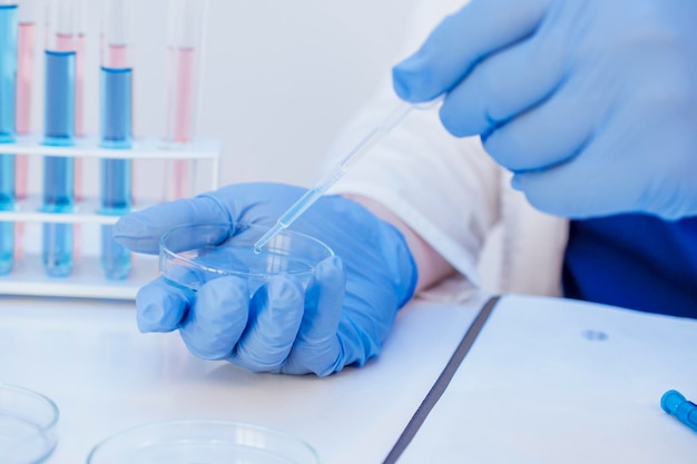 Medical insurance during a pandemic close up medical doctor in uniform and gloves puts vaccine