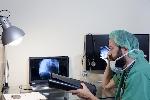 In the medical laboratory the patient undergoes an MRI or CT scan under the supervision of a radiologist in the control room the doctor observes the procedure and monitors the scan results