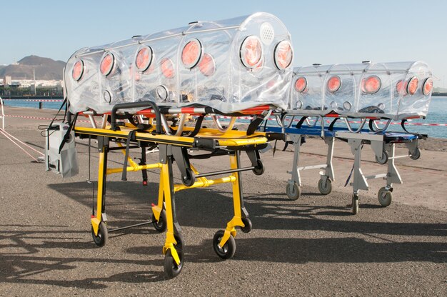 medical man with ambulance bed isolated for virus or nuclear alarm