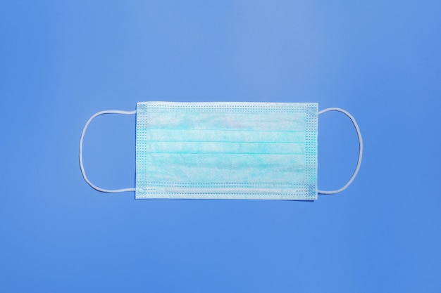 Photo medical mask on a blue background top view