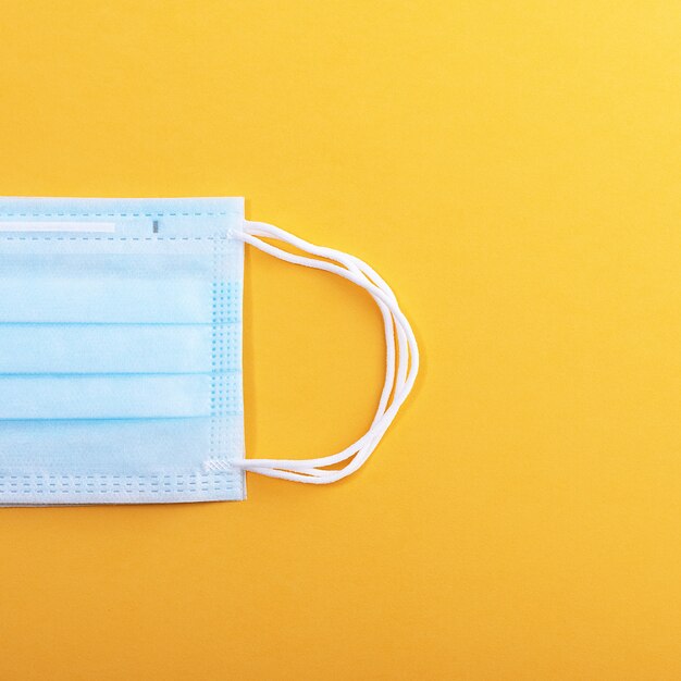 Medical mask protective. Isolated on a yellow background.