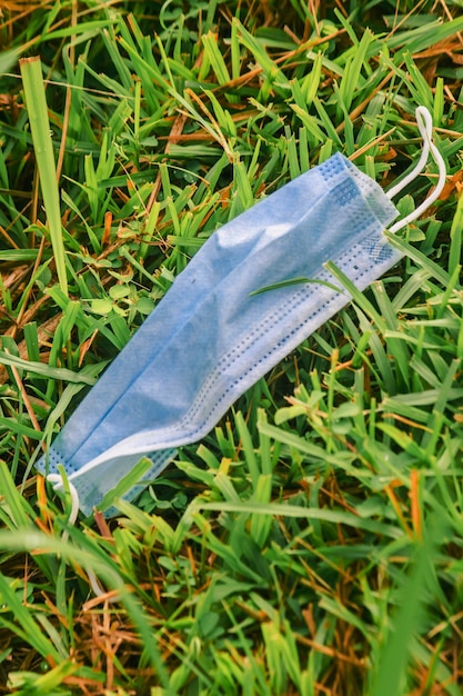 Medical mask was dropped on the grass