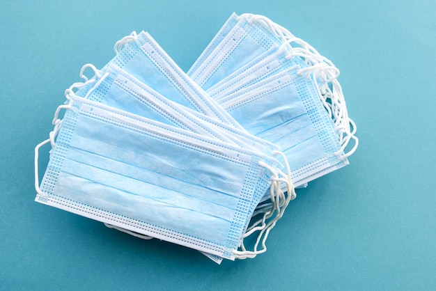 Medical masks on a clear blue background