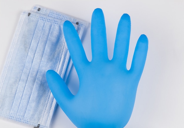 Photo medical masks and gloves on a white background. coronavirus protection concept