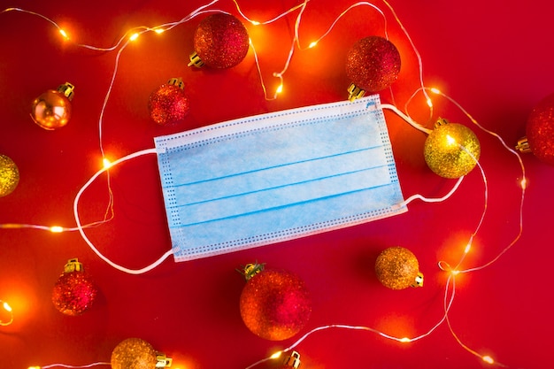 Medical masks with christmas toys balls. new year in quarantine