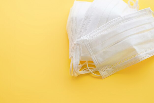 Medical masks on a yellow background