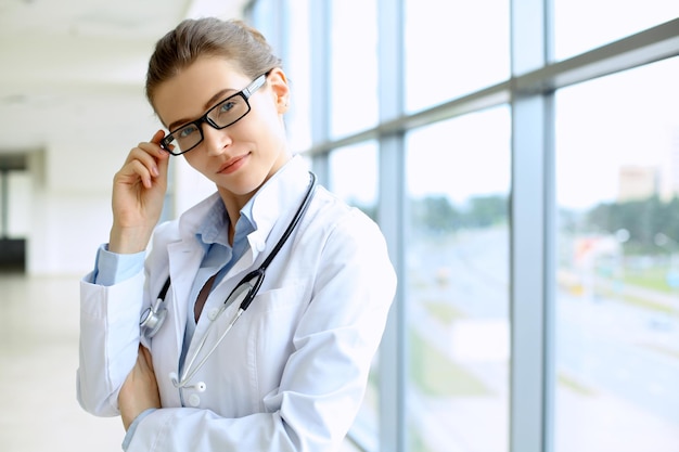 Medical physician doctor woman over blue clinic background