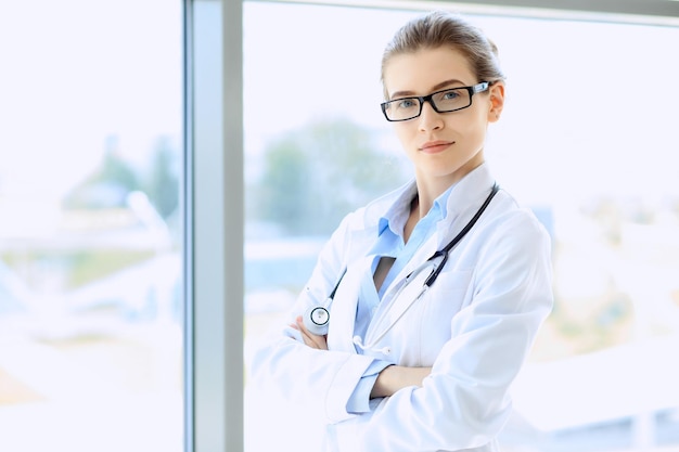 Medical physician doctor woman over blue clinic background