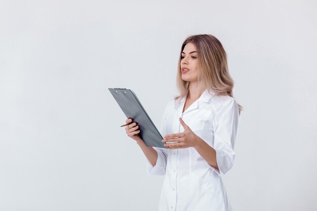 Medical physician doctor woman in white coat holds folder