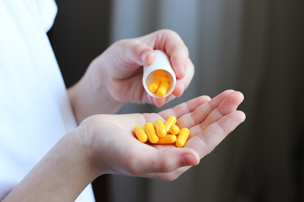 Medical pills in the hands of a child closeup