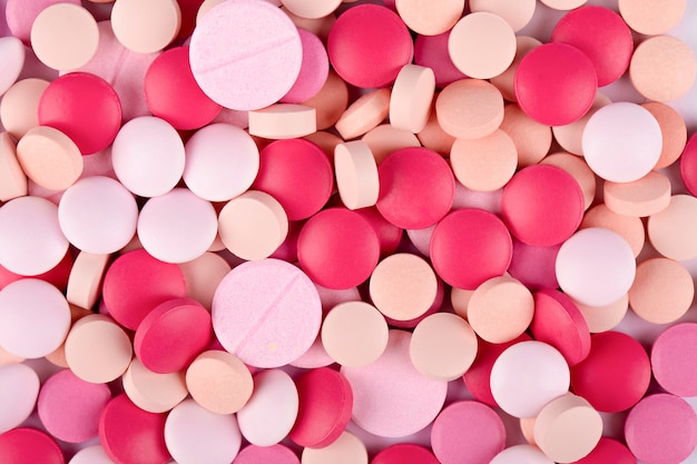 medical pills pink and white background