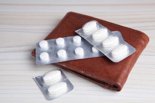 Medical pills with wallet on the table