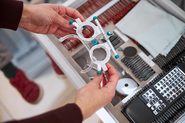 Medical practitioner taking a trial frame from a case