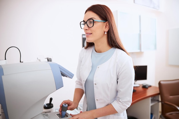 Medical professional using joystick of an autorefractor