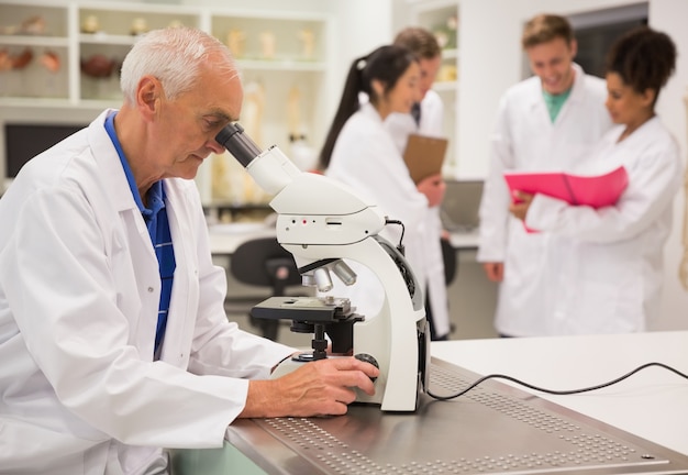 Medical professor working with microscope