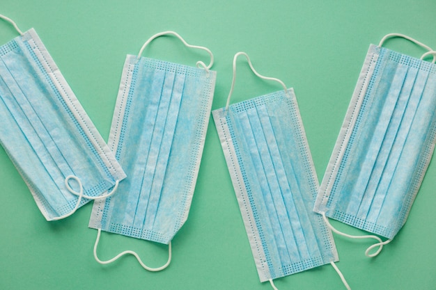 Medical protective masks on a mint background