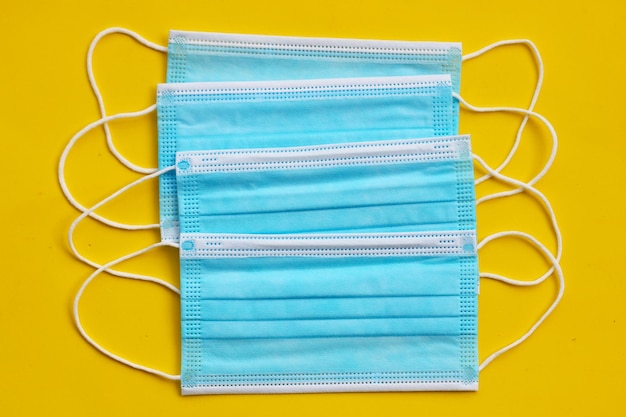Medical protective masks on yellow background