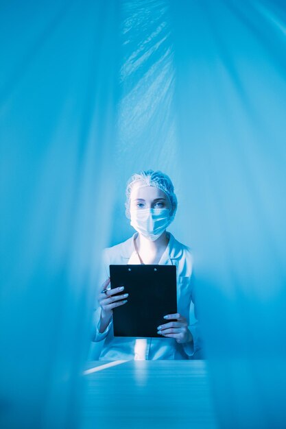 Medical record doctor in face mask with clipboard