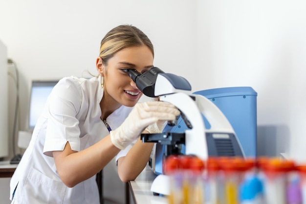 Medical Science Laboratory Beautiful Scientist Looking Under Microscope Does Analysis of Test Sample Young Specialists Using Advanced Technology Equipment