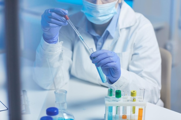 Medical scientist holding experiments with liquids