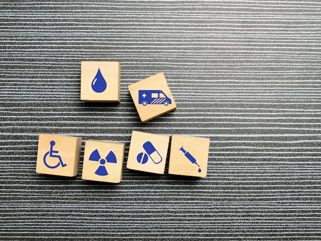 Medical services concept with icons on wooden cubes.