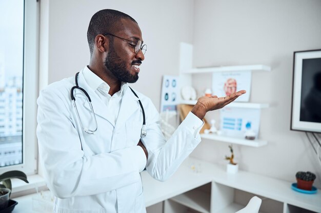 Medical specialist introducing an object in his office