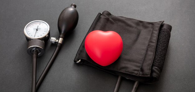 Medical sphygmomanometer on black background closeup view