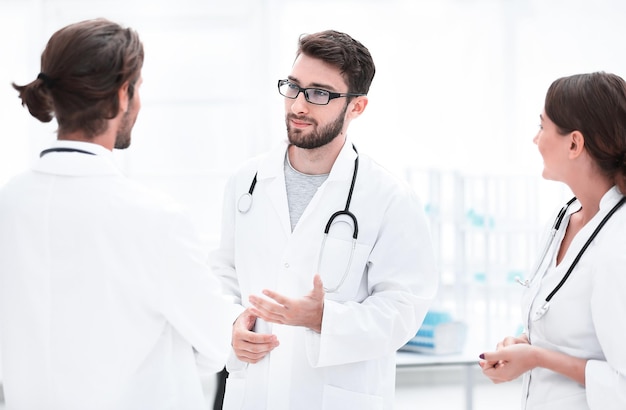 Medical staff discuss in a modern hospital room